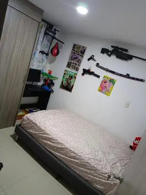 a bedroom with a bed and pictures on the wall at Edificio sefi in Medellín