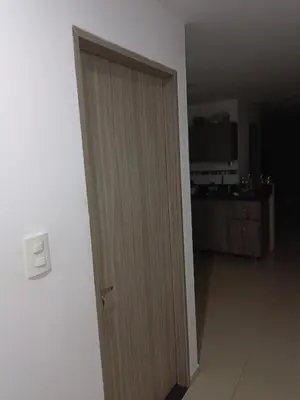 a wooden door in a room with a kitchen at Edificio sefi in Medellín
