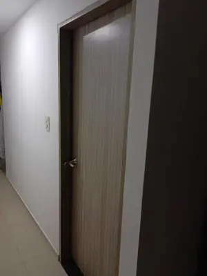 a wooden door in a room with a white wall at Edificio sefi in Medellín