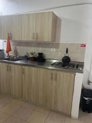 a kitchen with wooden cabinets and a counter top at Home river in Itagüí