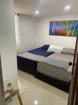 a bedroom with a bed with a painting on the wall at Pilar house in Medellín