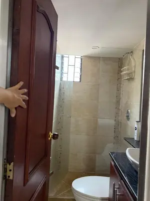 a bathroom with a toilet and a sink and a shower at Pilar house in Medellín
