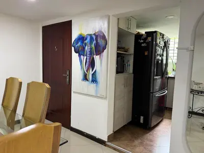 a kitchen with a painting of an elephant on the wall at Pilar house in Medellín