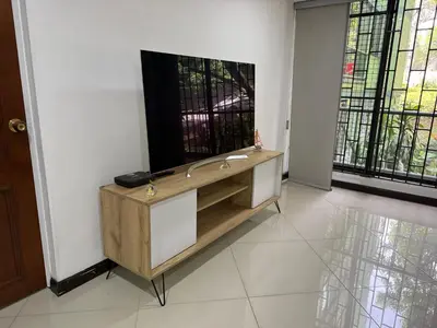 a living room with a flat screen tv on the wall at Pilar house in Medellín
