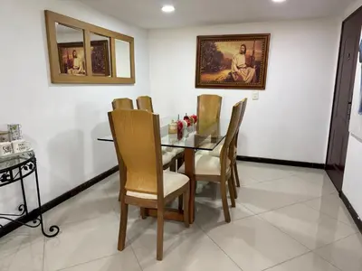 a dining room with a glass table and chairs at Pilar house in Medellín