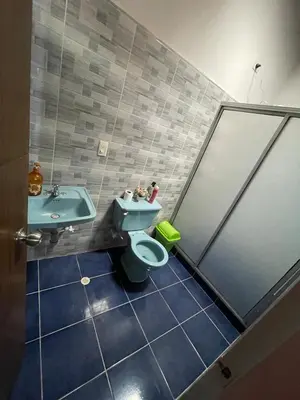 a bathroom with a toilet and a sink at Tu rincón en Medellín in Medellín