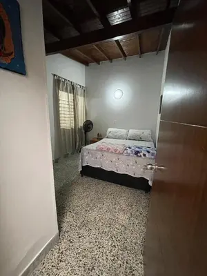 a bedroom with a bed in the corner of a room at Tu rincón en Medellín in Medellín