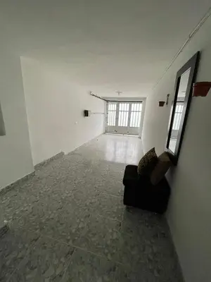 an empty room with a couch and a window at Tu rincón en Medellín in Medellín