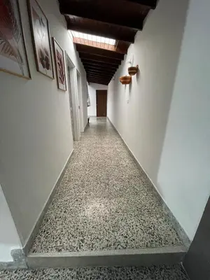 an empty hallway with a tile floor and a ceiling at Tu rincón en Medellín in Medellín