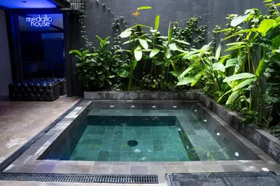 a small pool in the middle of a building with plants at Provenza luxury parque Lleras D'house, happy house in Medellín