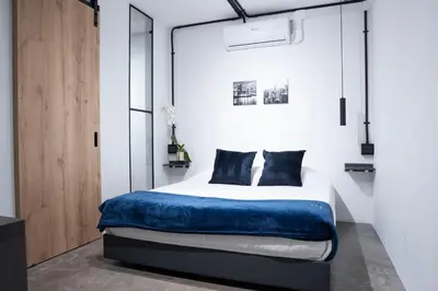 a bedroom with a bed with a blue blanket at Provenza luxury parque Lleras D'house, happy house in Medellín