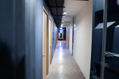 a long corridor with blue walls and a long hallway at Provenza luxury parque Lleras D'house, happy house in Medellín