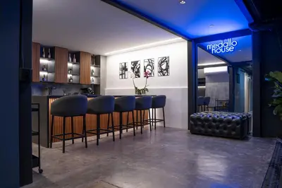 a bar with blue lighting in a restaurant with bar stools at Provenza luxury parque Lleras D'house, happy house in Medellín