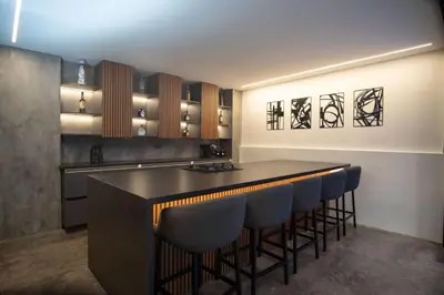 a kitchen with a bar with blue bar stools at Provenza luxury parque Lleras D'house, happy house in Medellín