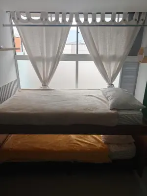 a bed in a room with a window at apartaestudio in Medellín
