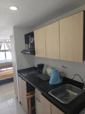 a kitchen with a sink and a counter top at apartaestudio in Medellín