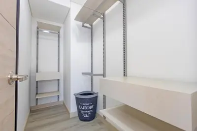 a hallway with white shelves and a trash can at El Poblado Prime Location Medellin Apt in Medellín