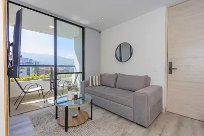a living room with a couch and a table at El Poblado Prime Location Medellin Apt in Medellín