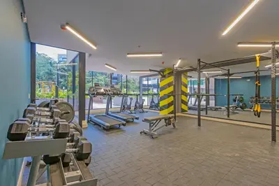 a gym with a bunch of equipment in a room at El Poblado Prime Location Medellin Apt in Medellín