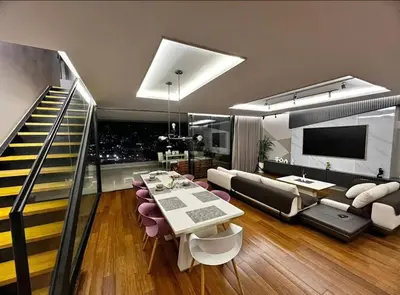 a living room with a dining table and a couch at Medellín Skyview penthouse in Medellín