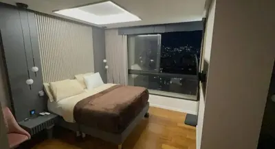 a small bedroom with a bed and a window at Medellín Skyview penthouse in Medellín