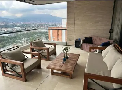 a living room with chairs and a couch and a table at Medellín Skyview penthouse in Medellín