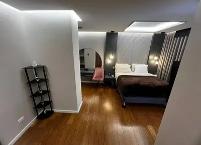 a bedroom with a bed and a desk and a mirror at Medellín Skyview penthouse in Medellín