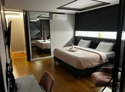 a bedroom with a large bed and a mirror at Medellín Skyview penthouse in Medellín
