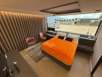 a bedroom with a bed and a large window at Medellín Skyview penthouse in Medellín