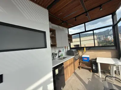 a kitchen with a large window and a counter top at Medellín Skyview penthouse in Medellín