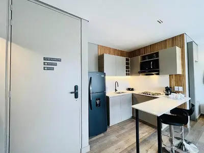 a small kitchen with a blue refrigerator and a table at Prime Stays L55 in San Antonio de Pereira