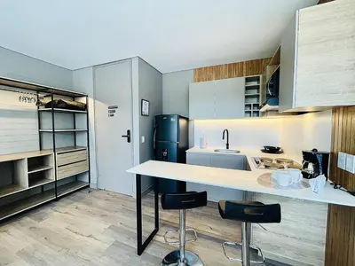 a kitchen with a white counter and a refrigerator at Prime Stays L55 in San Antonio de Pereira