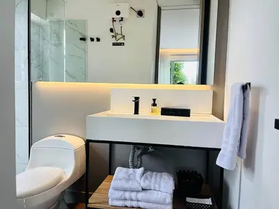 a bathroom with a sink and a toilet and a mirror at Prime Stays L55 in San Antonio de Pereira