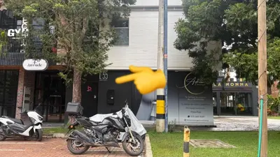 two motorcycles parked on a street in front of a building at Prime Stays L55 in San Antonio de Pereira