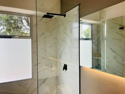 a bathroom with a shower with a glass door at Prime Stays L55 in San Antonio de Pereira