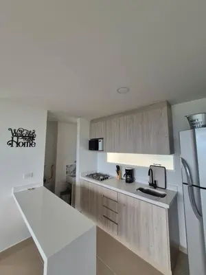 a kitchen with white cabinets and a white refrigerator at Apartasol Moderno bajo el Sol de Santa Fe in Santa Fe de Antioquia