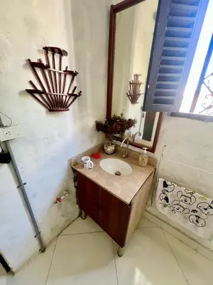 a bathroom with a sink and a mirror at Cabaña en Santorini in Puerto Triunfo