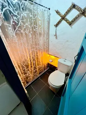 a bathroom with a toilet and a shower curtain at Cabaña en Santorini in Puerto Triunfo