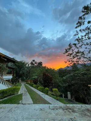 a sunset over a path in a garden at Playa Primavera in San Carlos