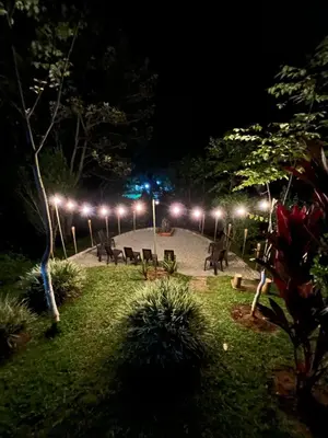 a park with chairs and lights at night at Playa Primavera in San Carlos