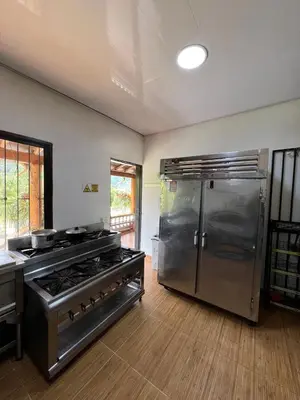 a kitchen with a stove and a refrigerator at Playa Primavera in San Carlos