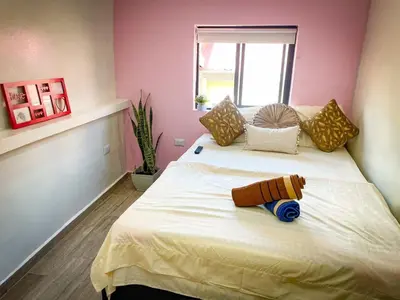 a bedroom with a bed with a teddy bear on it at DUo Nido in Medellín
