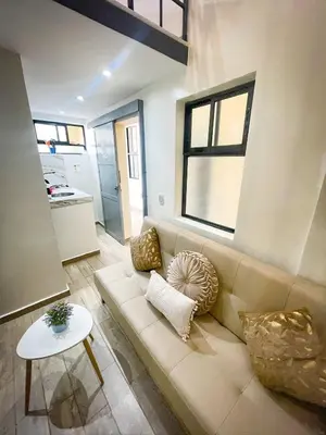 a living room with a couch and a table at DUo Nido in Medellín