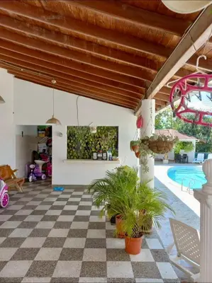 a patio with a checkered floor and a pool at Finca De Lujo En Copacabana Antioquia in Copacabana