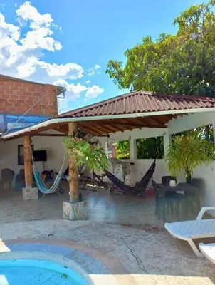 a patio with a pavilion and a swimming pool at Finca De Lujo En Copacabana Antioquia in Copacabana