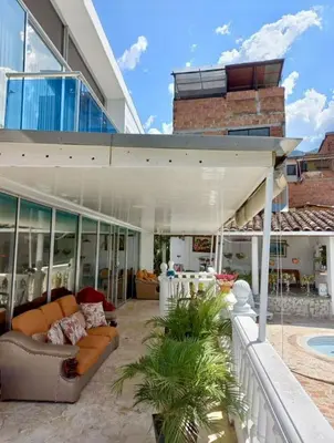 a house with a patio with a couch at Finca De Lujo En Copacabana Antioquia in Copacabana