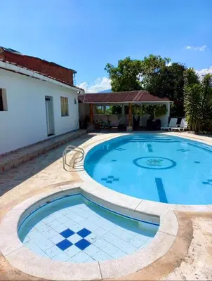a large swimming pool in the middle of a yard at Finca De Lujo En Copacabana Antioquia in Copacabana