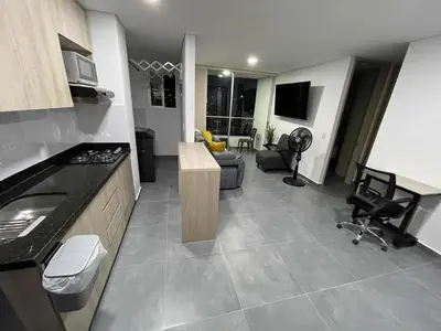a kitchen and living room with a couch and a table at Amplio y acogedor Apartamento en Sabaneta cerca al parque in Sabaneta