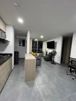 a kitchen and a living room with a couch and a table at Amplio y acogedor Apartamento en Sabaneta cerca al parque in Sabaneta