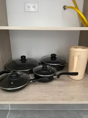 four frying pans sitting on a counter in a kitchen at Amplio y acogedor Apartamento en Sabaneta cerca al parque in Sabaneta